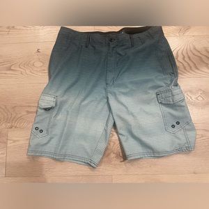 OCEAN CURRENT board shorts, teal with white horizontal pin stripes.EUC